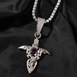 Macro detail of gothic demon sword necklace with purple zircon and bat wings