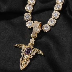 Macro shot of hip hop sword pendant with purple oval stone and zircon wings