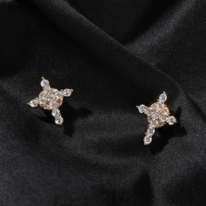 Macro shot of 8mm gold magnetic stud earrings with iced-out cubic zirconia cross design