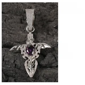 Close-up of hip hop pendant with dragon wings, purple gem, and cubic zirconia stones