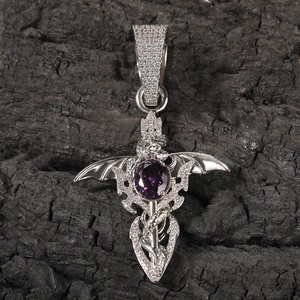 Macro shot of silver hip-hop sword pendant with purple gemstone and dragon wings detail