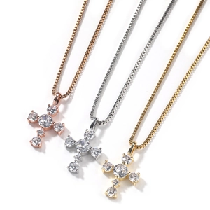 Three-color cross pendants in gold, silver, and rose gold with box chain details
