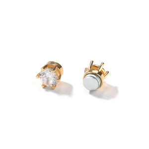 Detail view of 8mm gold magnetic stud earrings with round cubic zirconia and six-prong setting
