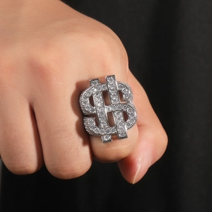 Detailed view of hip-hop money sign ring paved with white zircons on a model's hand