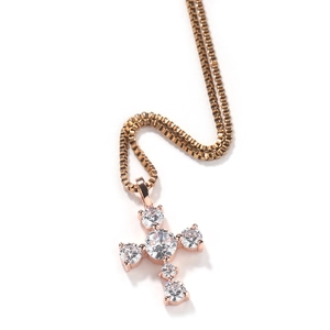 Close-up of rose gold cross pendant with six claw-set round cubic zirconia stones