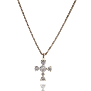 Macro detail of gold cross pendant with five sparkling round-cut cubic zirconia stones