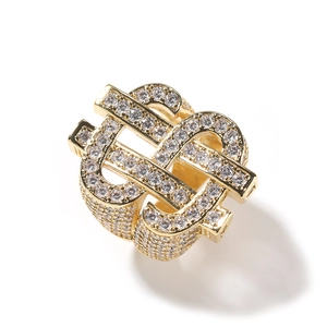 Macro detail of high-quality gold plating and pavé white zircons on a hip hop dollar ring