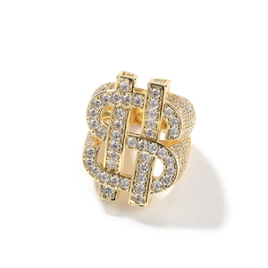 Macro detail of gold hip hop ring with dollar sign and micro-pave zircon settings