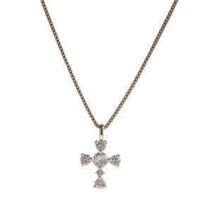Close-up of a gold-plated cross pendant featuring sparkling cubic zirconia stones and box chain