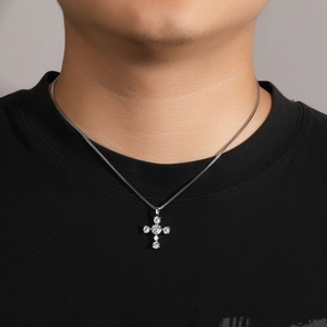 Close-up of S925 silver cross pendant necklace with zircon stones on male model wearer