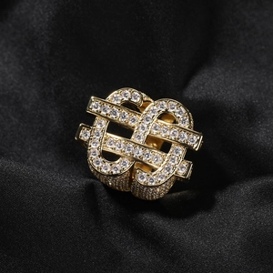 Detailed close-up of hip hop dollar sign ring with sparkling pavé zircons on black silk