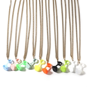 Detailed view of colorful silicone loops and gold metal chains for wireless earphones