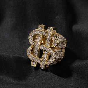 Macro view of gold hiphop ring featuring dollar sign design with micro-pave zircons