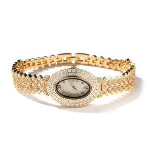 Gros plan sur la montre dorée ovale avec lunette en cristal et bracelet à maillons tressés