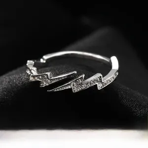 Macro view of interlocking double lightning bolt rings with inlaid cubic zirconia