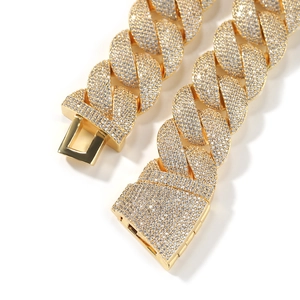 Macro shot of 24mm gold Cuban link chain with zircon micro-paving and clasp detail