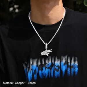 Close-up of hip hop gesture pendant with copper and cubic zirconia on tennis chain