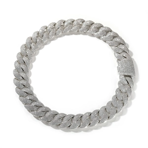 Macro view of silver tone Cuban link chain necklace with cubic zirconia and square clasp