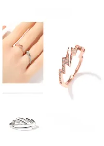 Close-up of hip-hop lightning rings in rose gold and silver with zircon stones