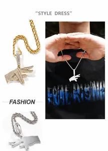 Macro detail of iced-out hip hop hand sign pendant necklace with zircon stones