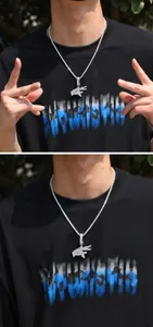 Close-up of hip-hop gesture pendant necklace with sparkling cubic zirconia on a tennis chain
