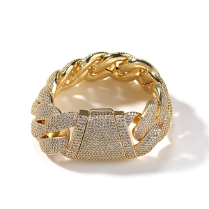 Macro detail of gold plated cuban link chain featuring micro-pave cubic zirconia setting