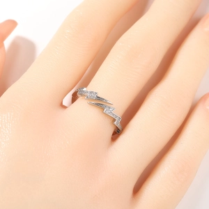 Macro detail of silver lightning bolt ring with sparkling cubic zirconia pavé stones