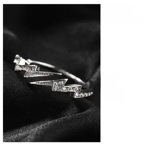 Macro shot of silver lightning ring with micro-set zircon stones on black velvet surface