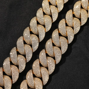 Macro shot of gold Cuban link chain necklace with detailed zircon pave setting