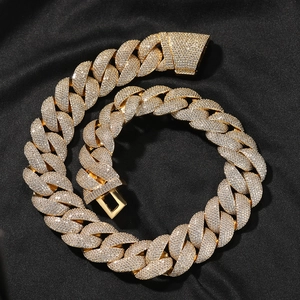 Close-up of iced out 24mm Cuban link chain with gold plating and sparkling zircon stones