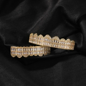 Macro detail of gold-plated hip hop grillz set with shiny baguette cut zircon stones