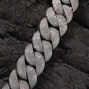 Close-up of hip-hop silver cuban link chain with high-density pave-set zircons on charcoal