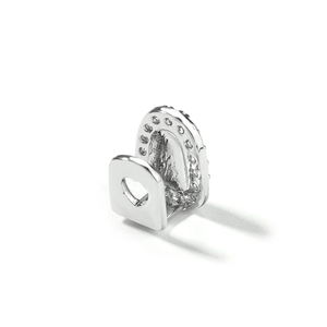 Detailed view of silver heart-shaped grillz with white zircon inlays and hollow design