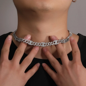 Close-up of iced out Cuban link necklace with zircon inlay on a male model neck