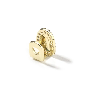 Hip hop style single gold tooth grillz featuring a heart-shaped cutout and pavé cubic zirconia