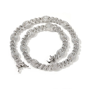 Macro detail of silver-colored Cuban link chain with paved high-quality zircons