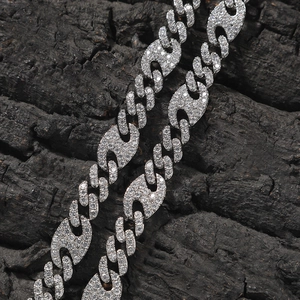 Macro shot of silver hip hop necklace with micro-pave zircons and wave-shaped links