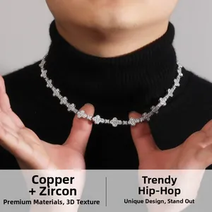 Detailed view of hip hop cross flower necklace with cubic zirconia on black sweater