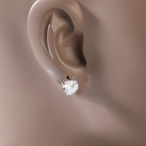 Gros plan de boucles d'oreilles cœur en zircon avec serti à griffes sur modèle d'oreille