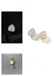 Detail view of heart-shaped hip hop stud earrings with baguette and pavé cubic zirconia