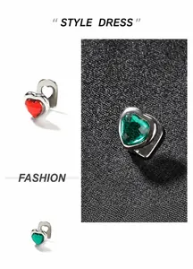 Macro detail of hip hop silver metal heart tooth grillz with inlaid ruby red crystal