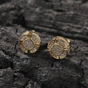 Macro detail of gold-plated hip-hop round stud earrings with pave-set zircon crystals