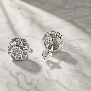 Macro view of iced out silver round stud earrings with pave set cubic zirconia stones