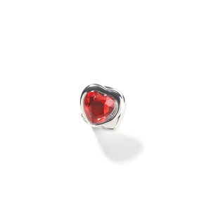 Detail shot of heart-shaped red gemstone set in a silver hip-hop style tooth grill