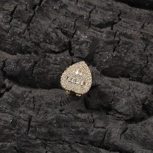 Detail of gold heart grillz featuring rectangular zircon and micro-pave crystals