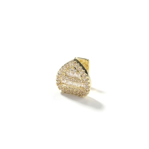 Macro shot of gold plated heart shaped grillz accessory with cubic zirconia inlay