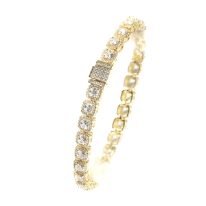 Macro detail of a 7mm gold tennis chain with square cut cubic zirconia halo setting