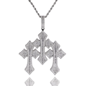Macro shot of silver hip hop cross pendant with pave baguette and round diamonds