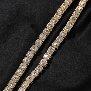 Macro shot of 7mm gold-plated hip hop ice cube chain with square cubic zirconia stones