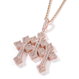 Macro view of rose gold hip hop triple layered cross pendant with baguette cubic zirconia